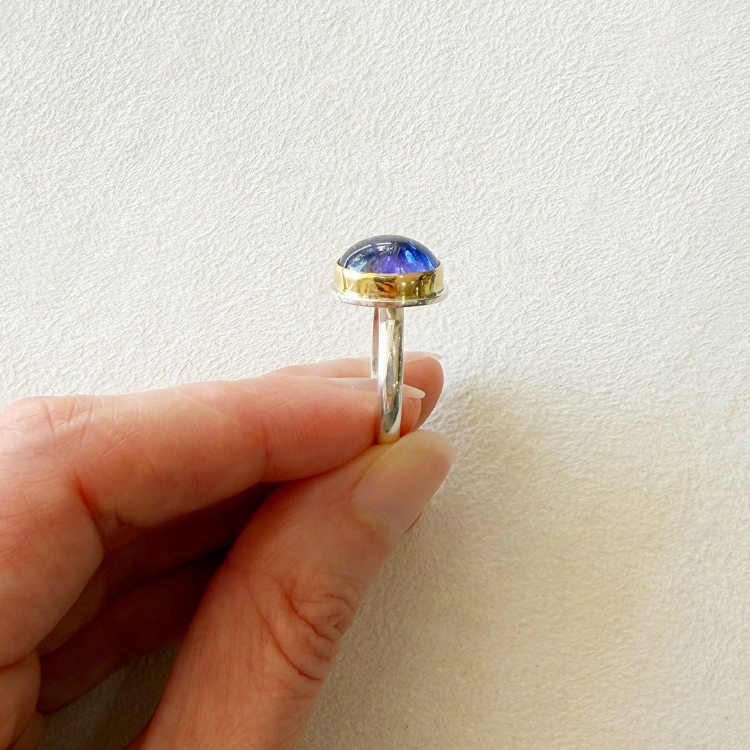 Side view of ring with a purple tanzanite gemstone 