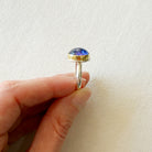 Side view of ring with a purple tanzanite gemstone 