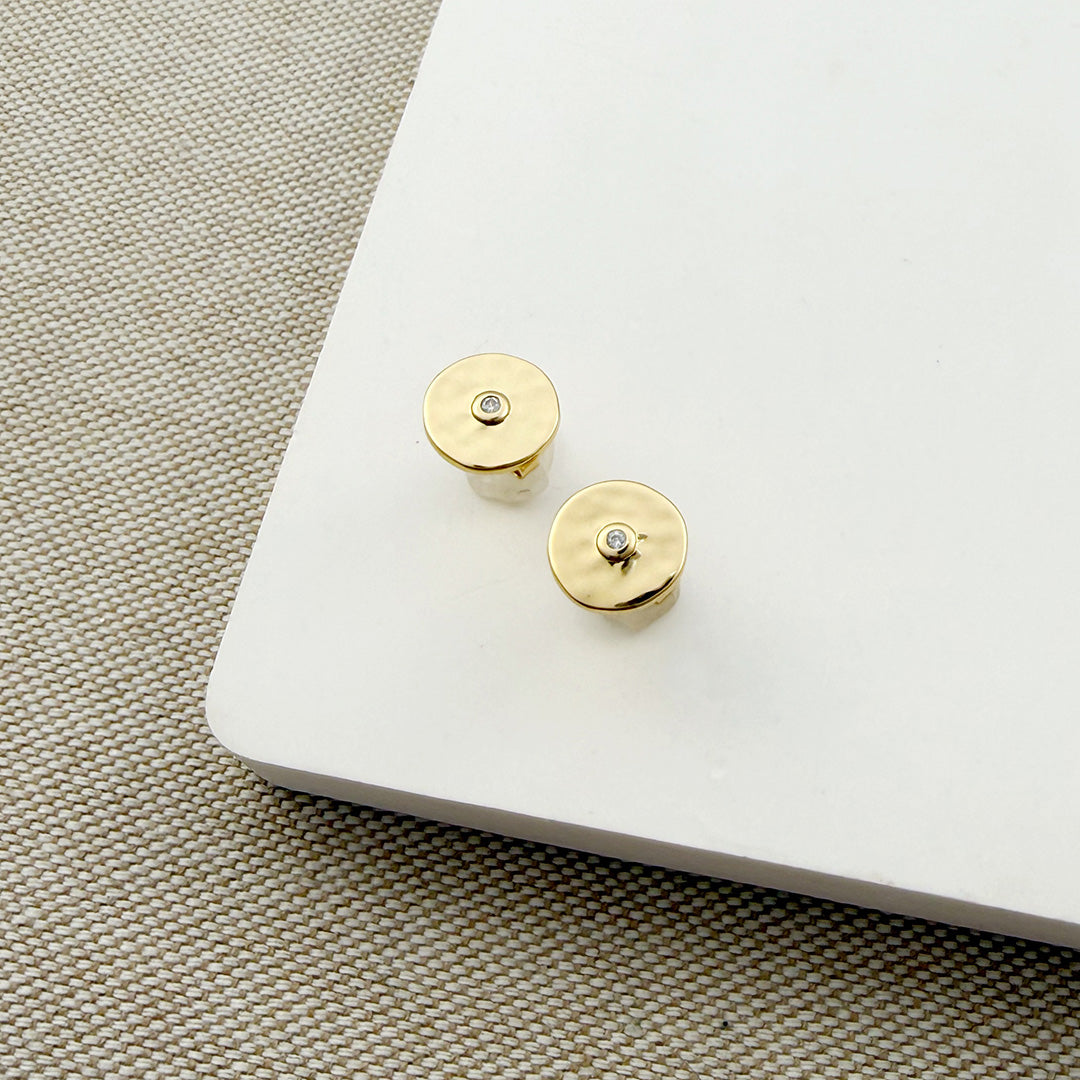 Hammered disc stud with a small inset CZ on a white background