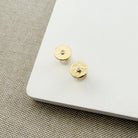 Hammered disc stud with a small inset CZ on a white background