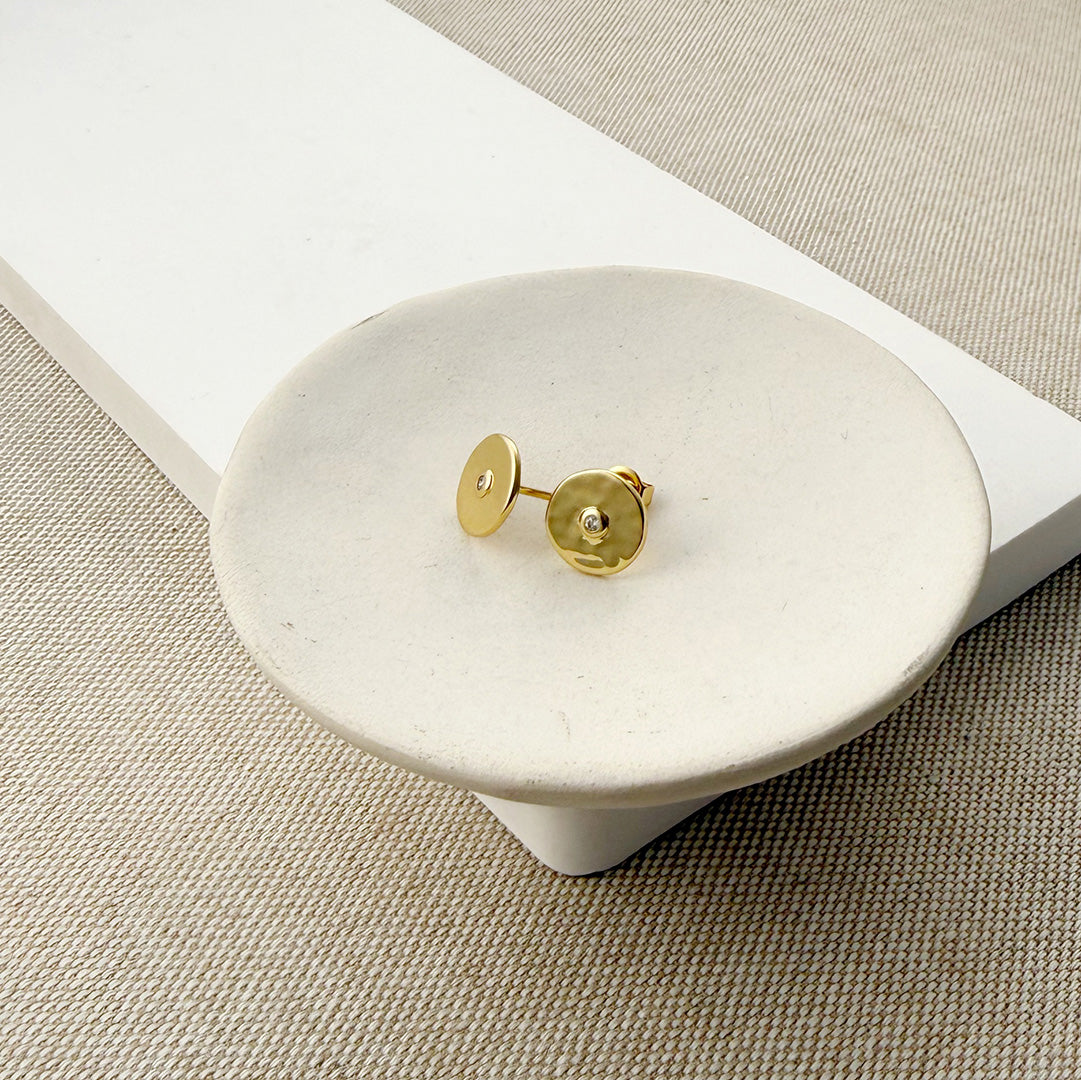Hammered disc stud with a small inset CZ on a white background