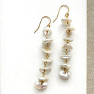 Pearl drop earrings on a white card