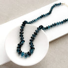 London Blue knotted necklace in a white dish