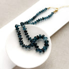 London Blue knotted necklace in a white dish