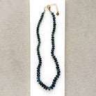 London Blue knotted necklace on a white dish