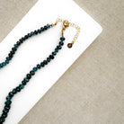 London Blue knotted necklace on a white dish
