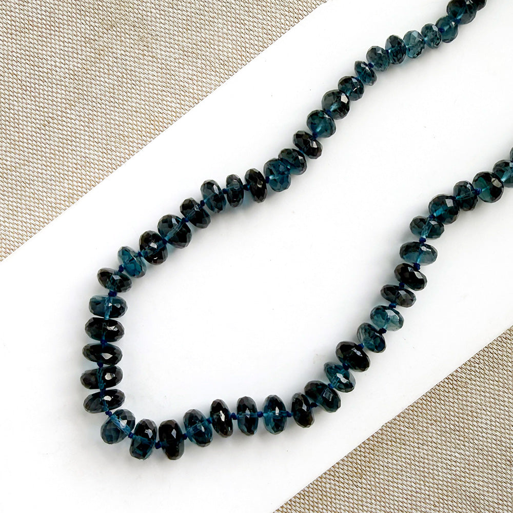 London Blue knotted necklace on a white dish