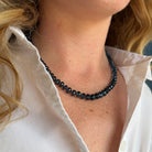 Close up of woman wearing London Blue topaz knotted necklace