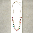Gold necklace with dangling teardrop-shaped Watermelon Tourmaline gemstones in pink, green, and teal on a white background