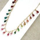 Gold necklace with dangling teardrop-shaped Watermelon Tourmaline gemstones in pink, green, and teal on a white background
