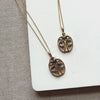 Two gold beetle pendants set with Montana sapphires