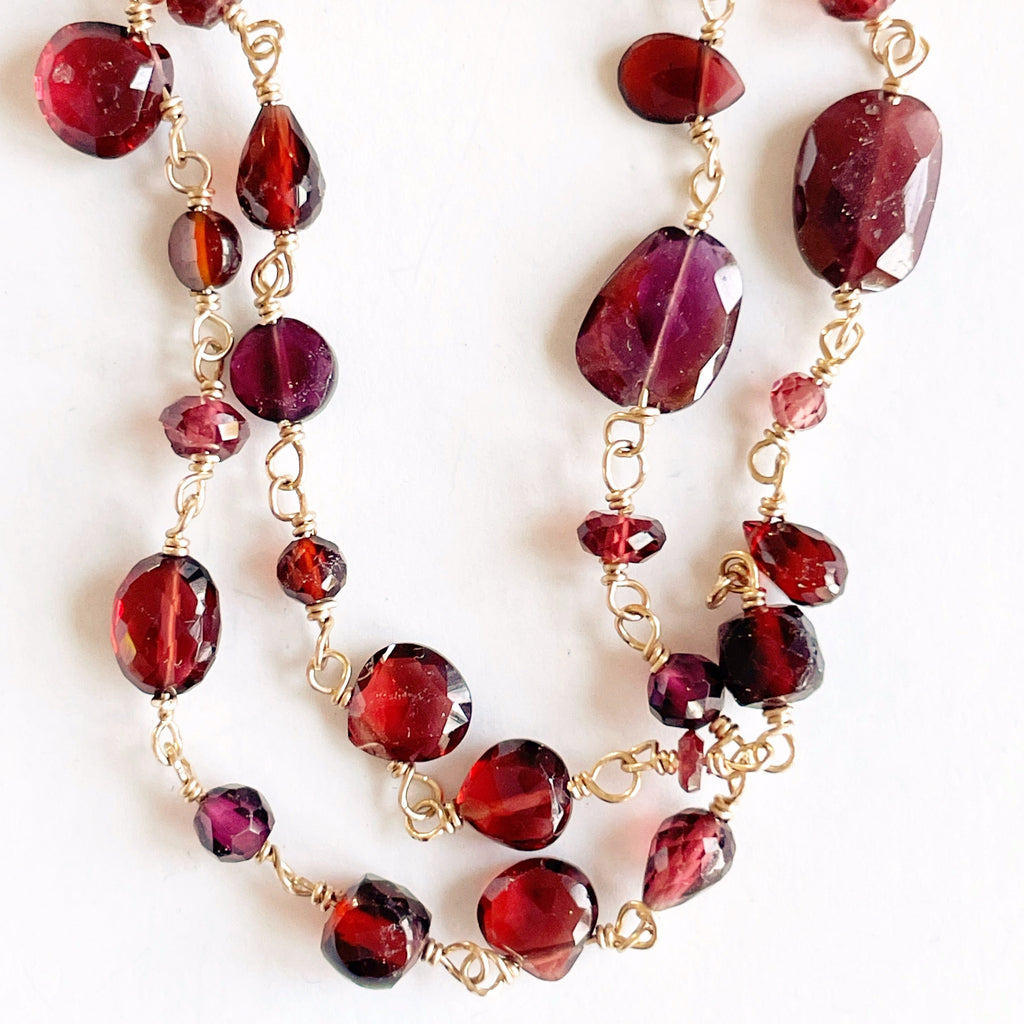 Gold and garnet long statement gemstone necklace with wire wrapped garnet gemstones. Poppy Garnet Necklace by Sarah Cornwell Jewelry