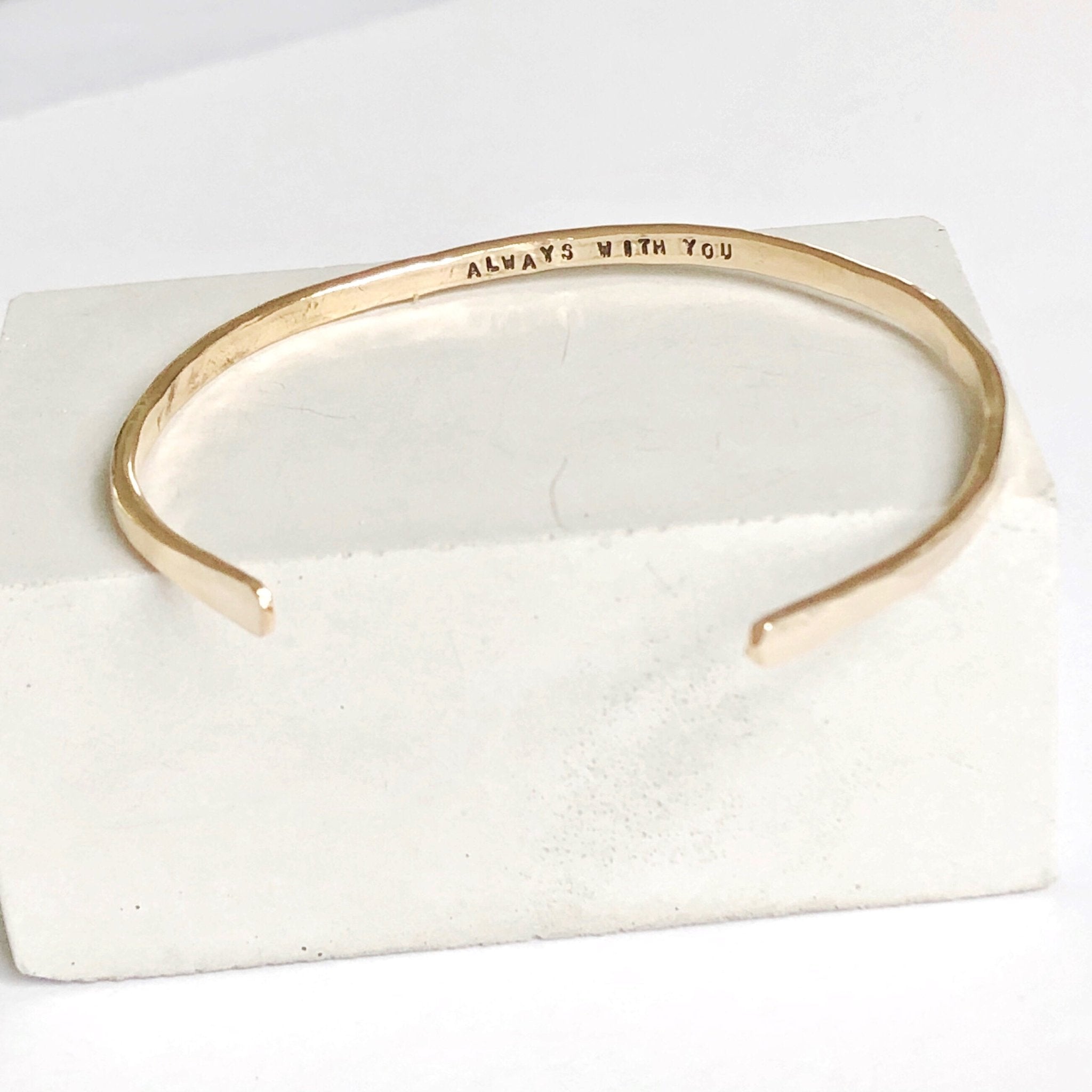 Gold textured bangle bracelet with the words "always with you" stamped on the inside. Always with You Bangle by Sarah Cornwell Jewelry