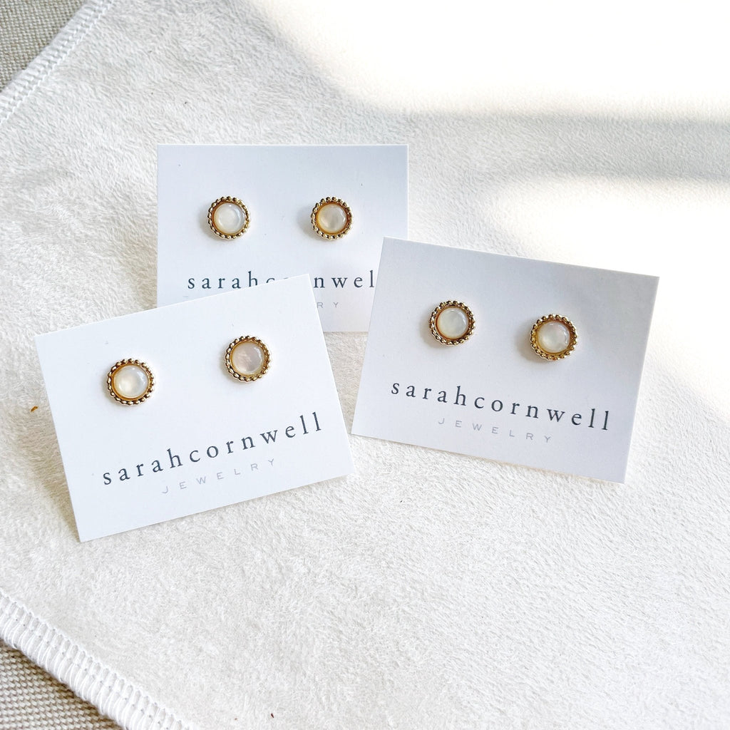 3 pairs of 6mm gold and mother of pearl stud earrings with a beaded bezel setting. Chantilly Studs by Sarah Cornwell Jewelry