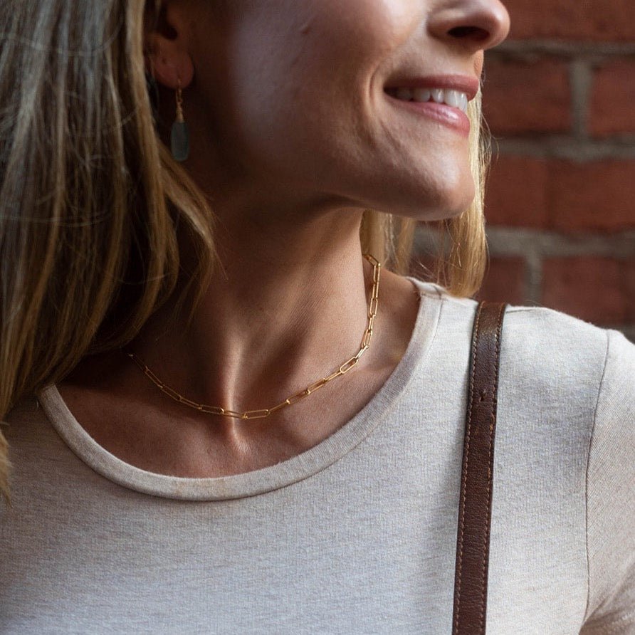 Woman wearing white t shirt with chunky large link paperclip chain layering necklace and chalcedony drop earrings. Charleston Necklace by Sarah Cornwell Jewelry