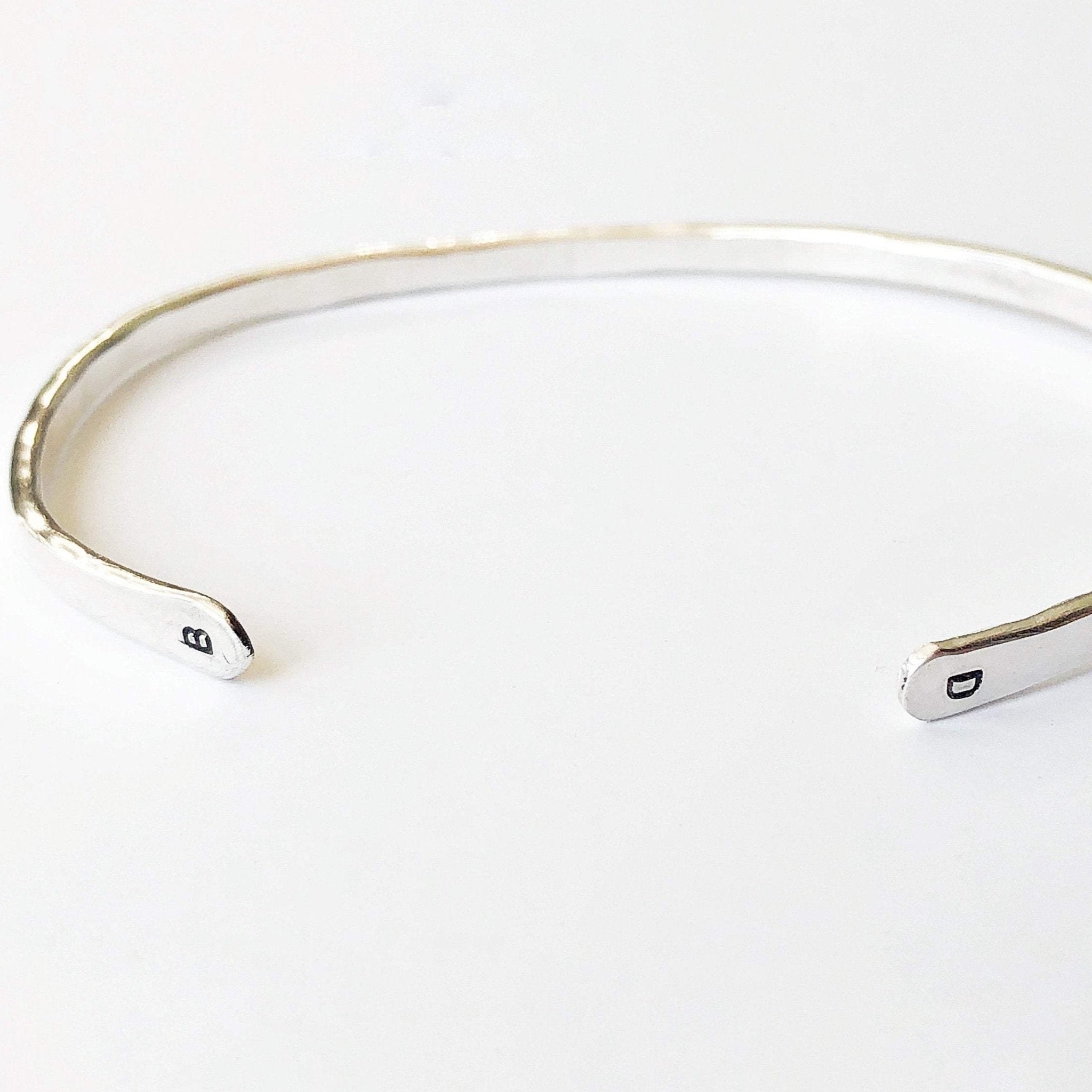 Silver textured bangle bracelet with initials stamped on both ends. Charlie Bangle by Sarah Cornwell Jewelry