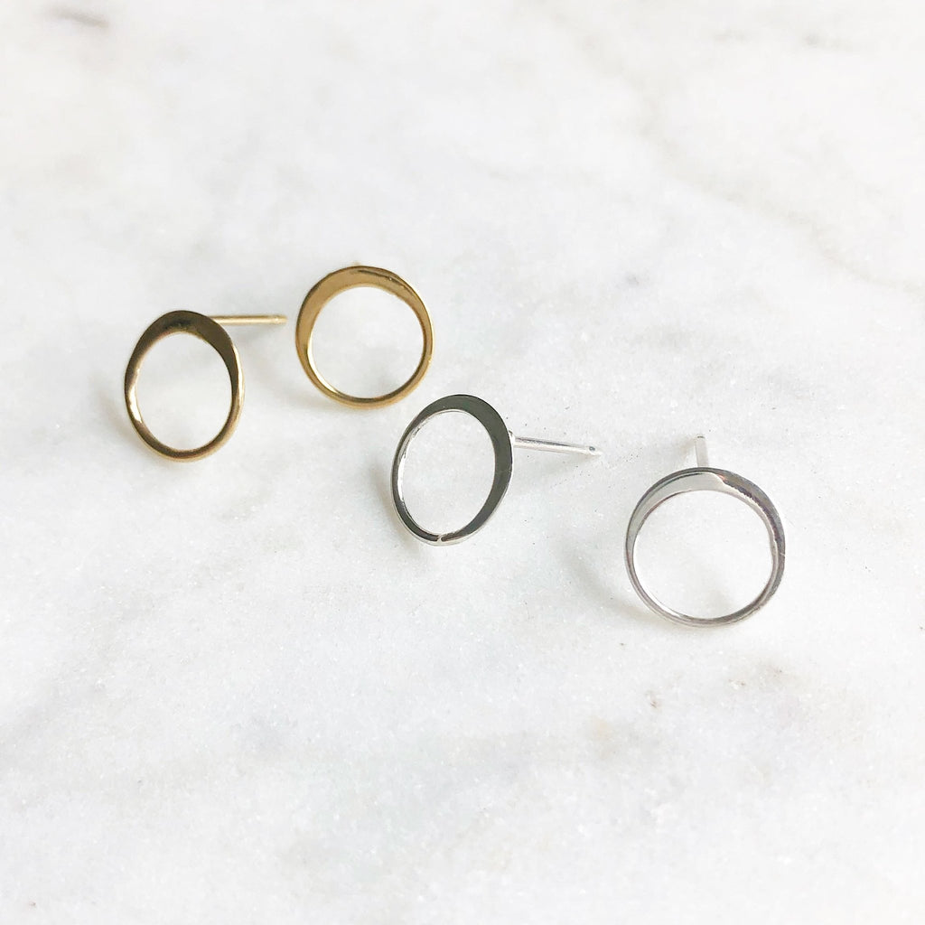 2 pairs of gold and silver simple circle stud earrings. Circle Studs by Sarah Cornwell Jewelry