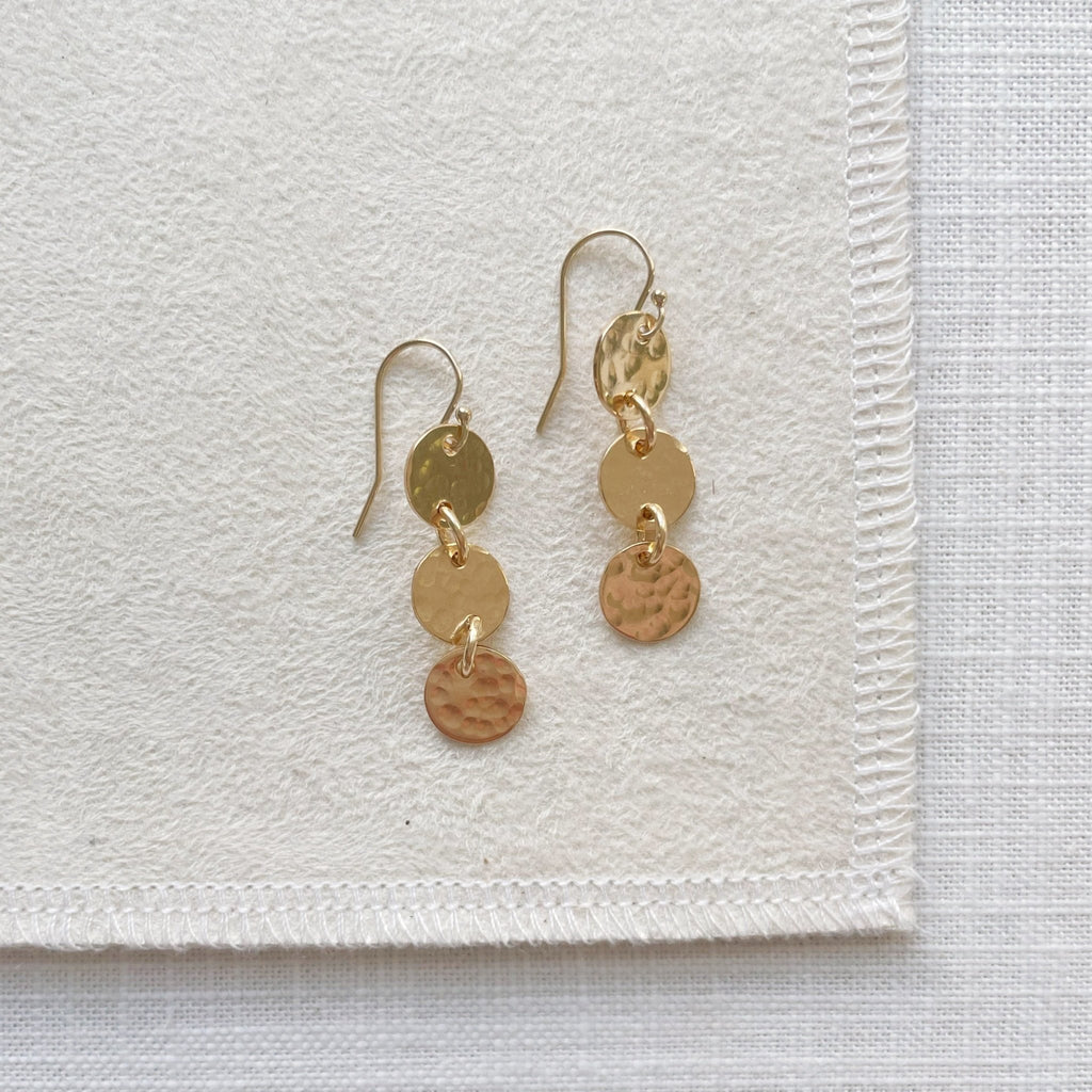 Gold 1.5 inch drop earrings with 3 same sized textured discs. Cole Earrings by Sarah Cornwell Jewelry