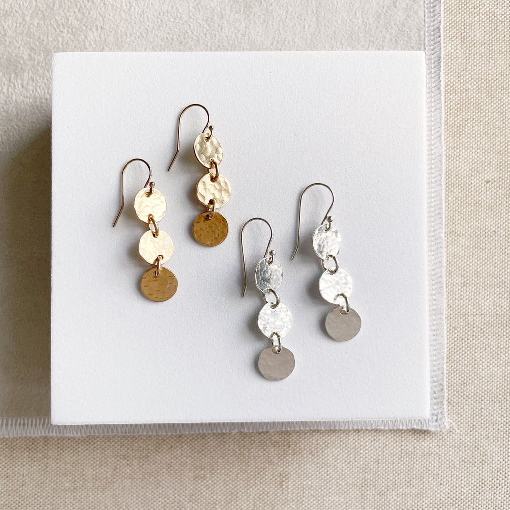 2 pairs of gold and silver 1.5 inch drop earrings with 3 same sized textured discs. Cole Earrings by Sarah Cornwell Jewelry