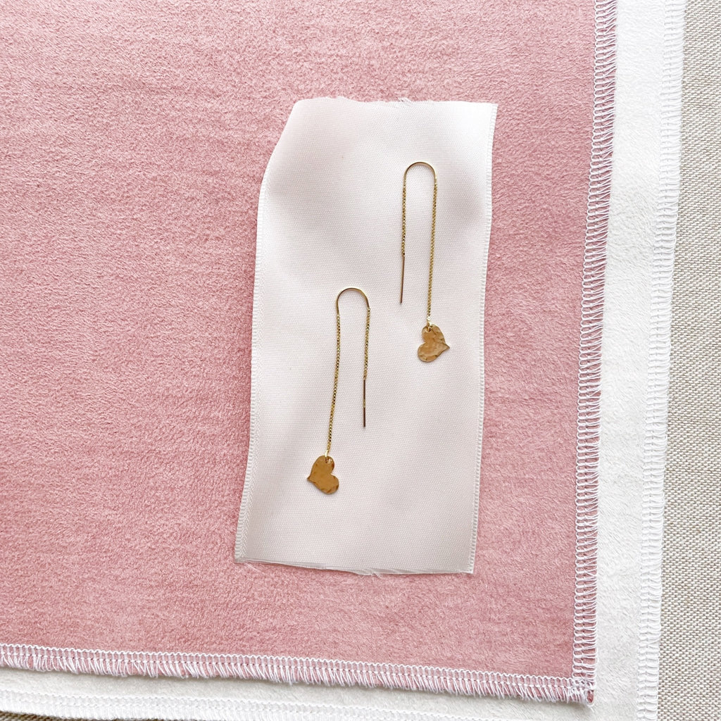 Gold chain threader earrings with a 2.25 inch drop and a tiny textured gold heart at the bottom. Darling Earrings by Sarah Cornwell Jewelry