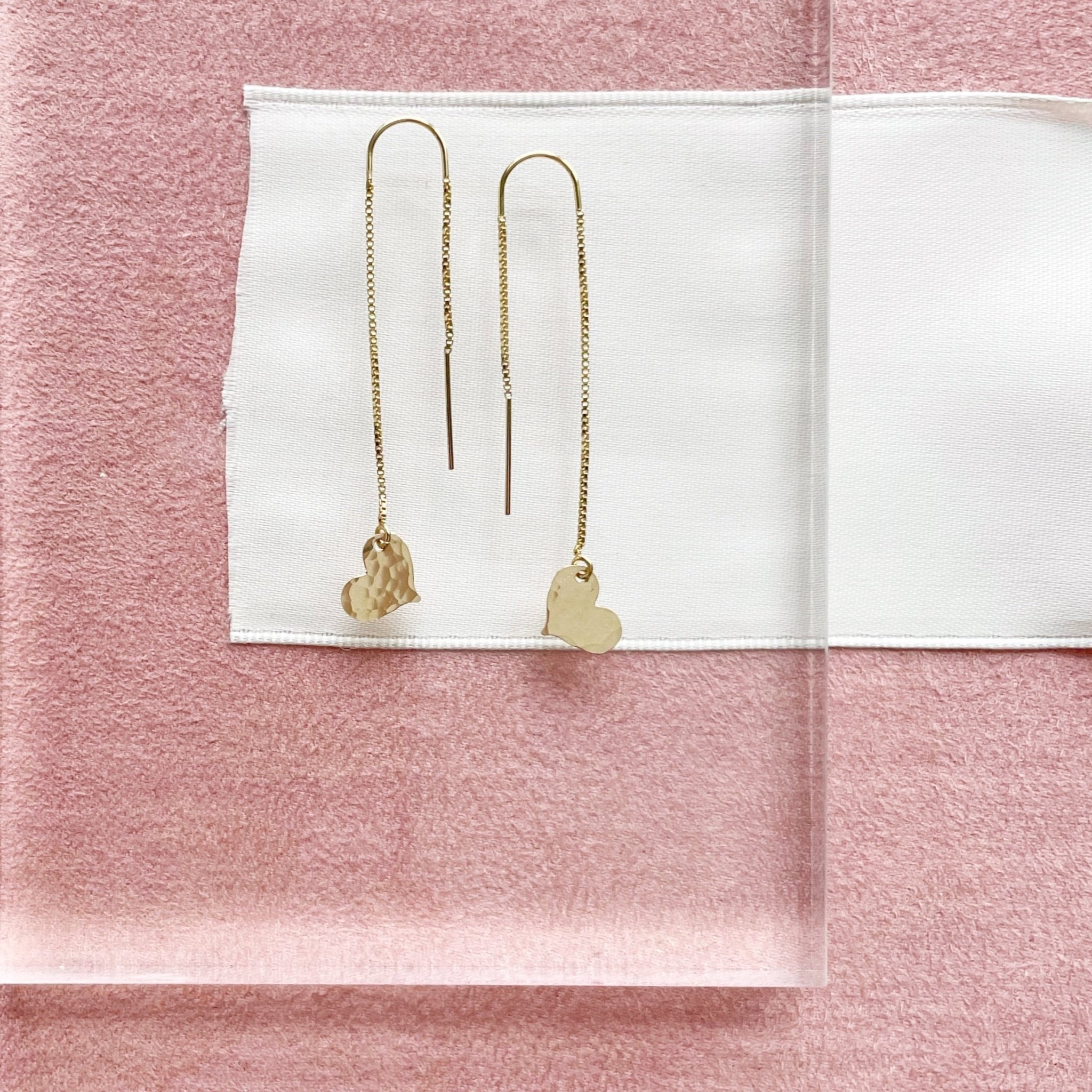 Gold chain threader earrings with a 2.25 inch drop and a tiny textured gold heart at the bottom. Darling Earrings by Sarah Cornwell Jewelry