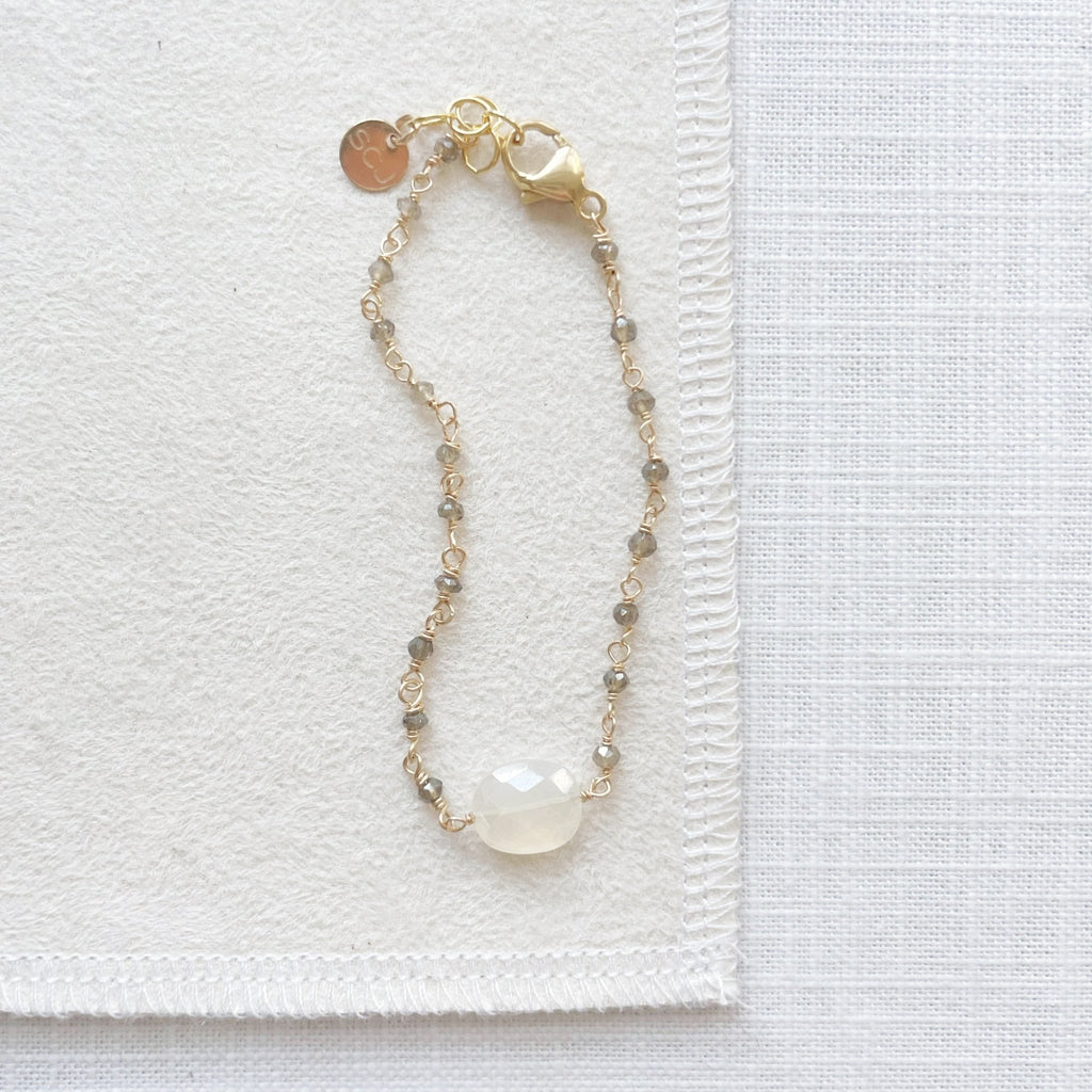 Gold gemstone bracelet with large white chalcedony and hand wire wrapped faceted smokey topaz gemstones. Gloria Bracelet by Sarah Cornwell Jewelry