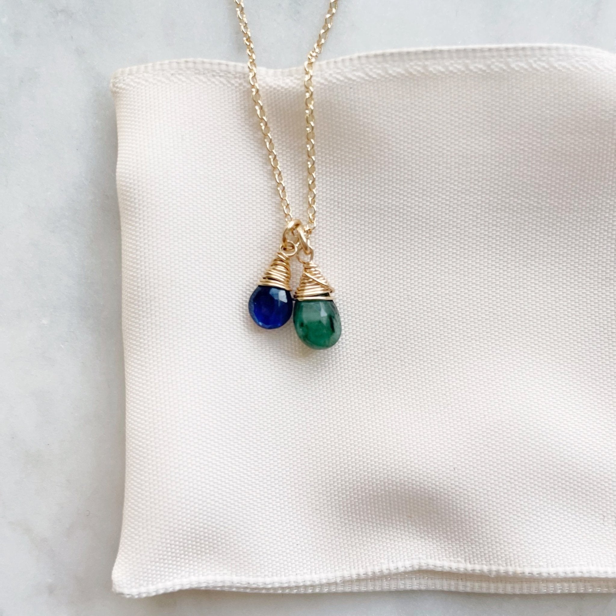 Gold wire wrapped gemstone birthstone necklace with blue and green gemstone pendants. Heritage Necklace by Sarah Cornwell Jewelry
