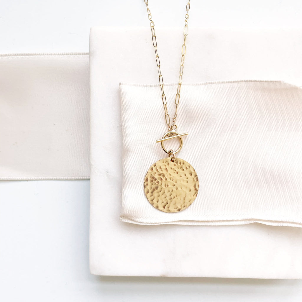 17.5 inch gold statement necklace with large gold textured disc, front toggle and rectangle chain. Josephine Necklace by Sarah Cornwell Jewelry