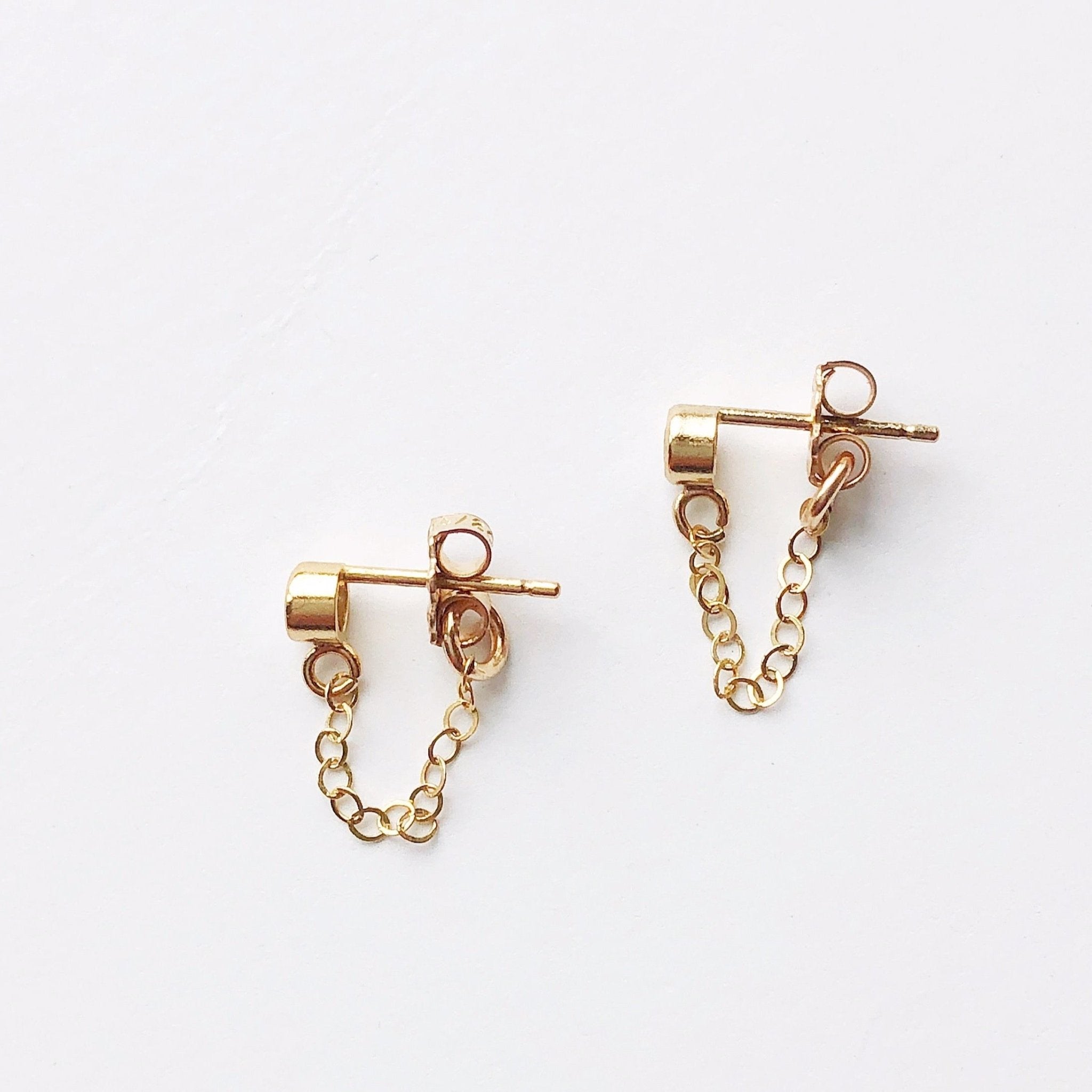 Side view of 3mm white topaz and gold chain stud earrings. Kate Studs by Sarah Cornwell Jewelry