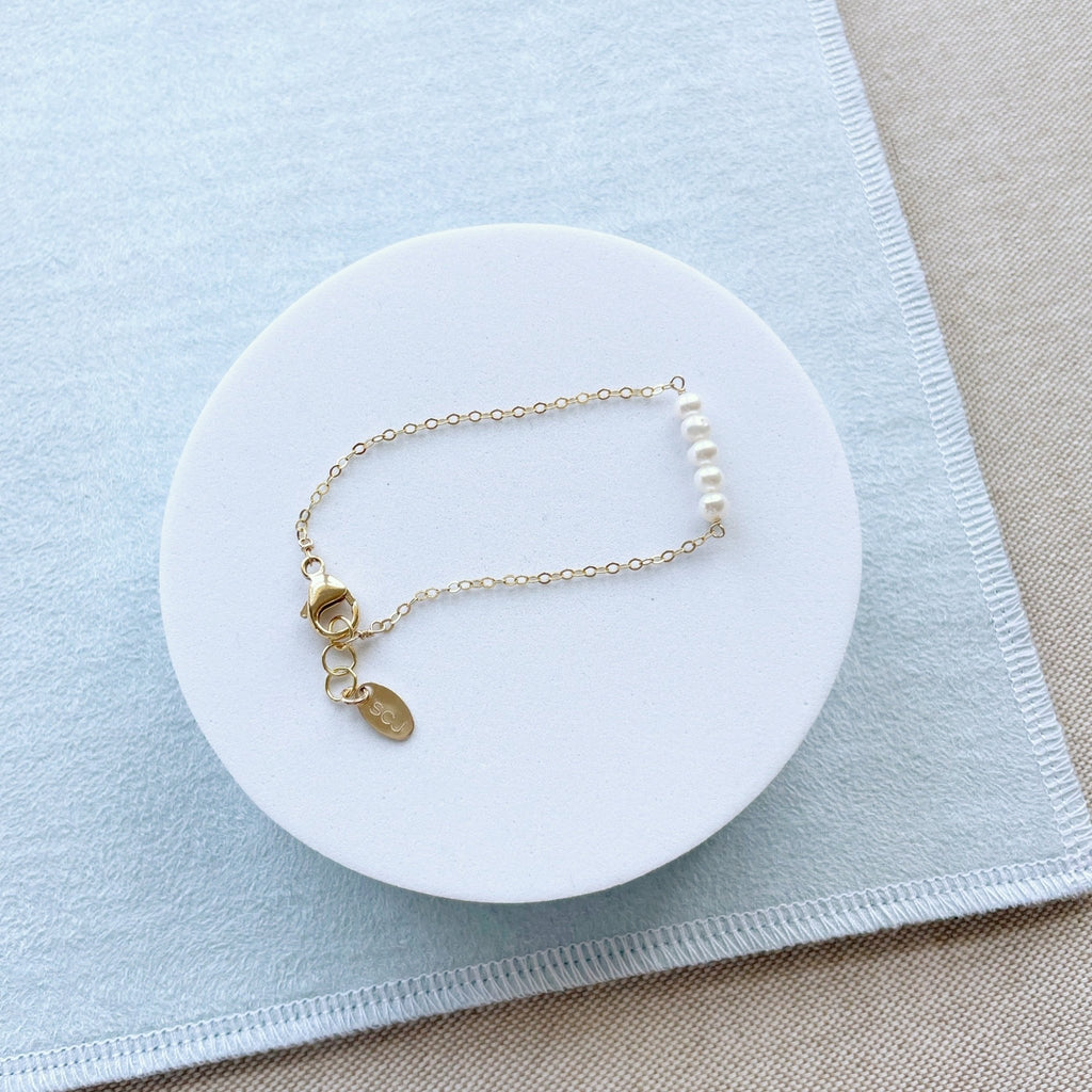 Gold and pearl bracelet with 5 side by side pearls. La Mere Bracelet by Sarah Cornwell Jewelry