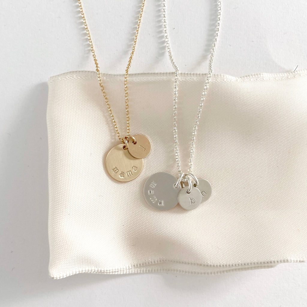 2 gold and silver mama stamped disc necklaces with one and 2 tiny stamped initial discs. Mama Necklace by Sarah Cornwell Jewelry