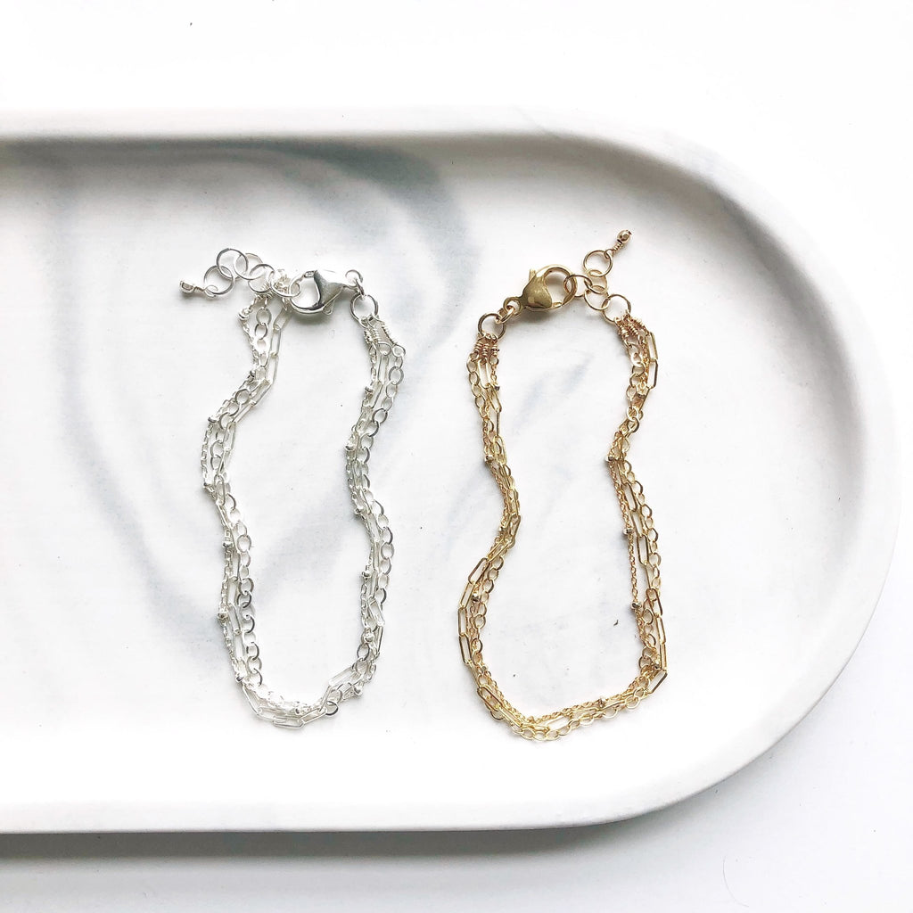 2 gold and silver 3 strand bracelets with rectangle chain, link chain, and link ball chains. Mina Bracelet by Sarah Cornwell Jewelry