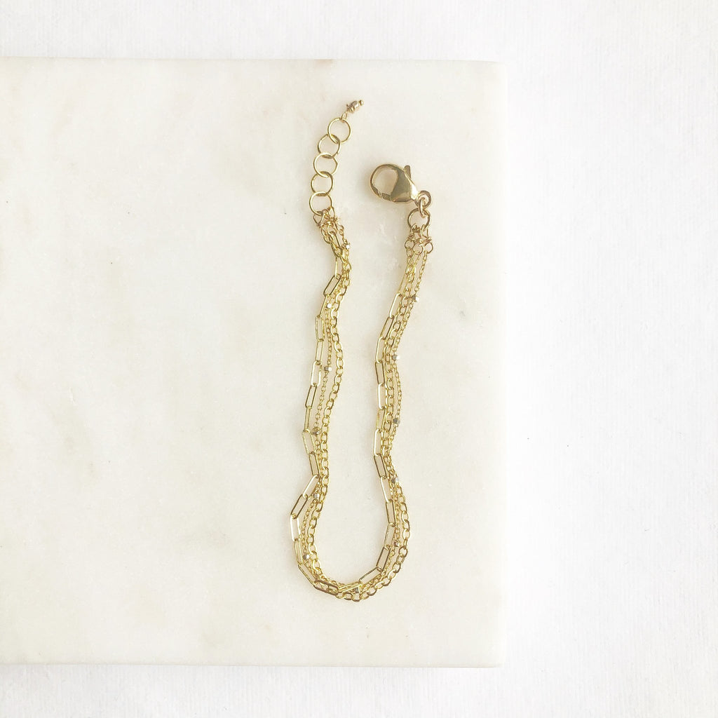 Gold 3 strand bracelet with rectangle chain, link chain, and link ball chains. Mina Bracelet by Sarah Cornwell Jewelry