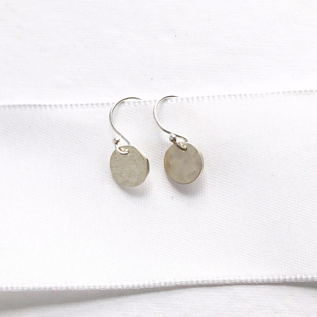 Silver Monica Earrings by Sarah Cornwell Jewelry. Shimmery, dainty silver 3/8 inch textured disc earrings on a white background.
