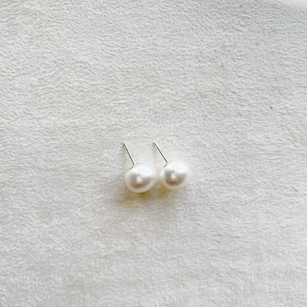 Oversized 9.5-10 mm creamy white oyster pearl stud earrings. Oyster Pearl Studs by Sarah Cornwell Jewelry
