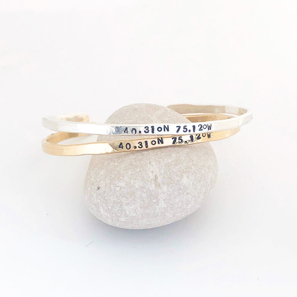 2 gold and silver textured bangle bracelets with stamped personalization on the outside. Personalized Caroline Bangle by Sarah Cornwell Jewelry