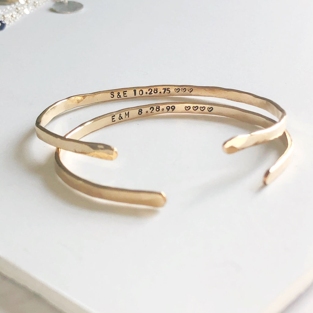 2 gold textured bangle bracelets with stamped personalization on the inside. Personalized Caroline Bangle by Sarah Cornwell Jewelry
