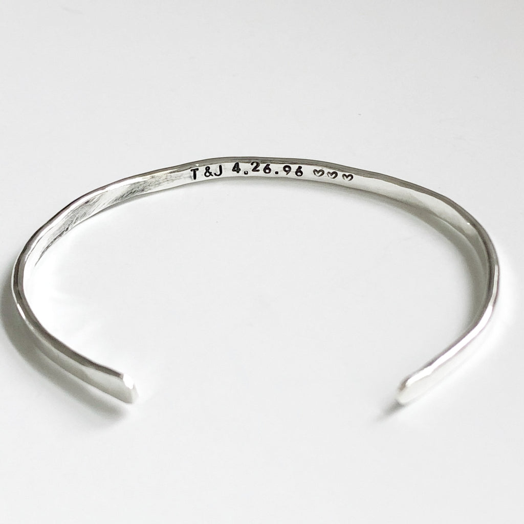 Silver textured bangle bracelet with stamped personalization on the inside. Personalized Caroline Bangle by Sarah Cornwell Jewelry