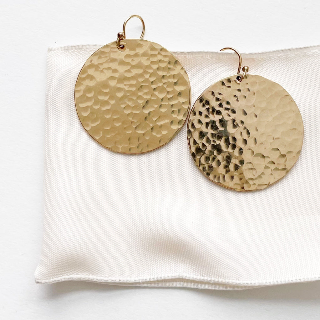 Gold Phoebe Earrings by Sarah Cornwell Jewelry.  Shimmery, textured 1.25 inch gold disc statement earrings on a white background.