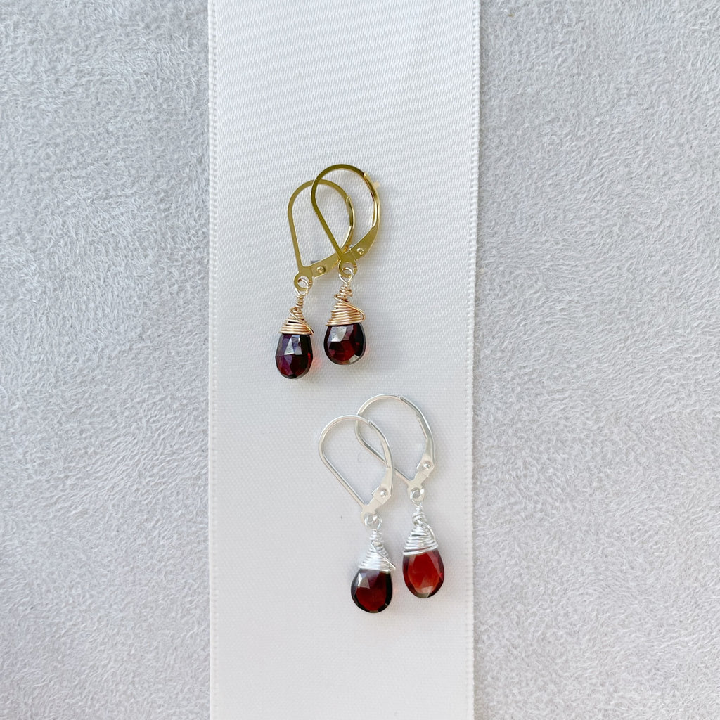 2 pairs of gold and silver wire wrapped garnet gemstone drop earrings with lever backs. Poppy Garnet Earrings by Sarah Cornwell Jewelry