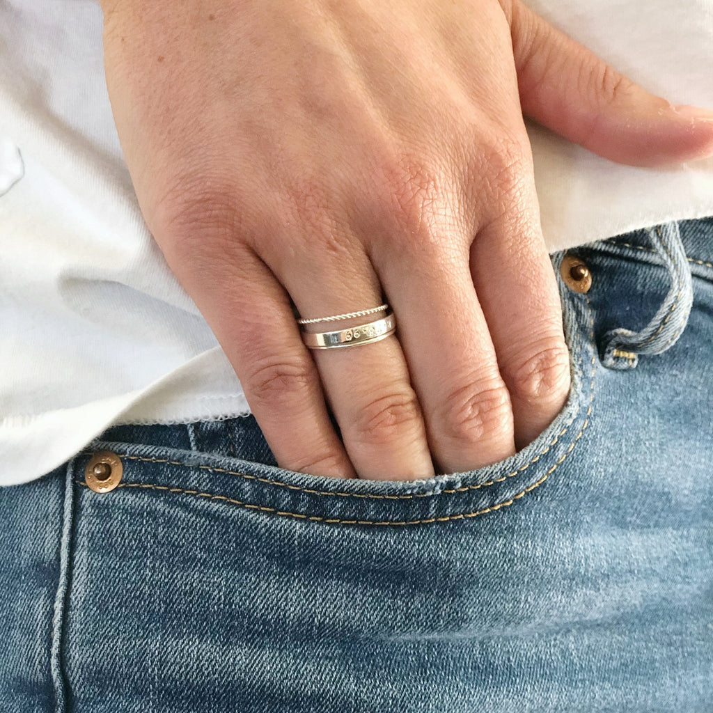 Woman's hand in denim pocket wearing gold wire ring and 2 other gold rings. Rowan Ring by Sarah Cornwell Jewelry