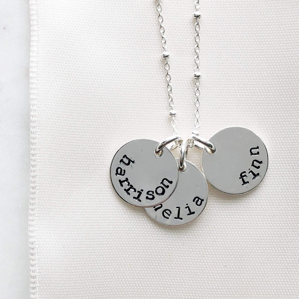 Silver stamped disc necklace with link ball chain and 3 personalized stamped name discs. Stella Necklace by Sarah Cornwell Jewelry