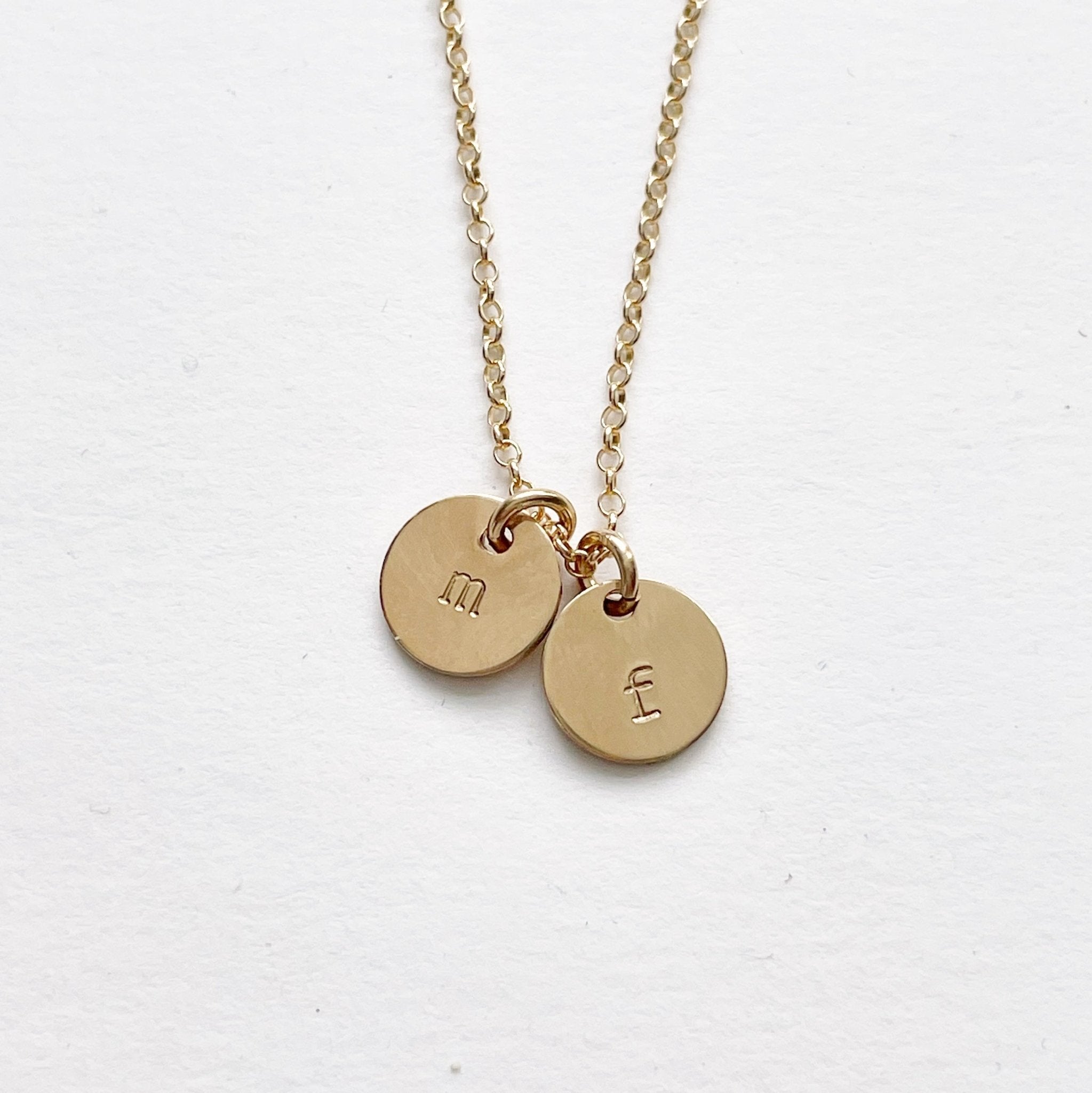 Gold stamped disc personalized initial necklace with 2 gold stamped discs with initials. Tabby Necklace by Sarah Cornwell Jewelry
