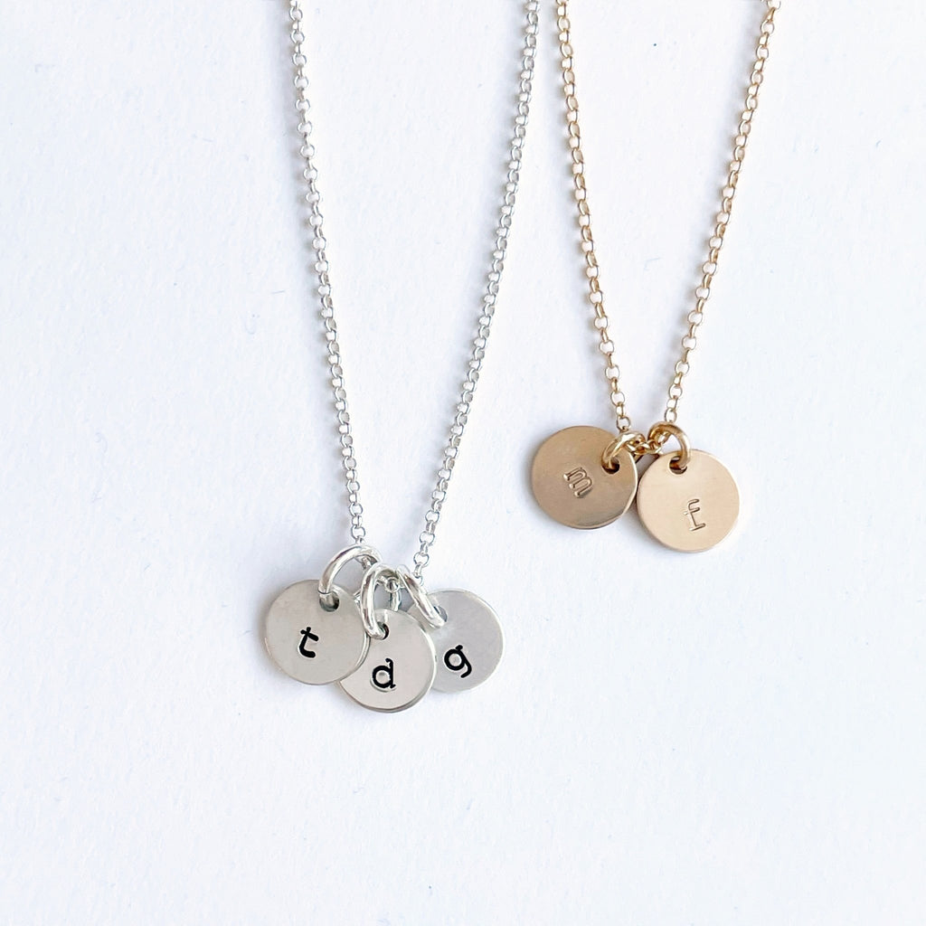 2 gold and silver stamped disc personalized initial necklaces with 3 and 2 stamped discs with initials. Tabby Necklace by Sarah Cornwell Jewelry