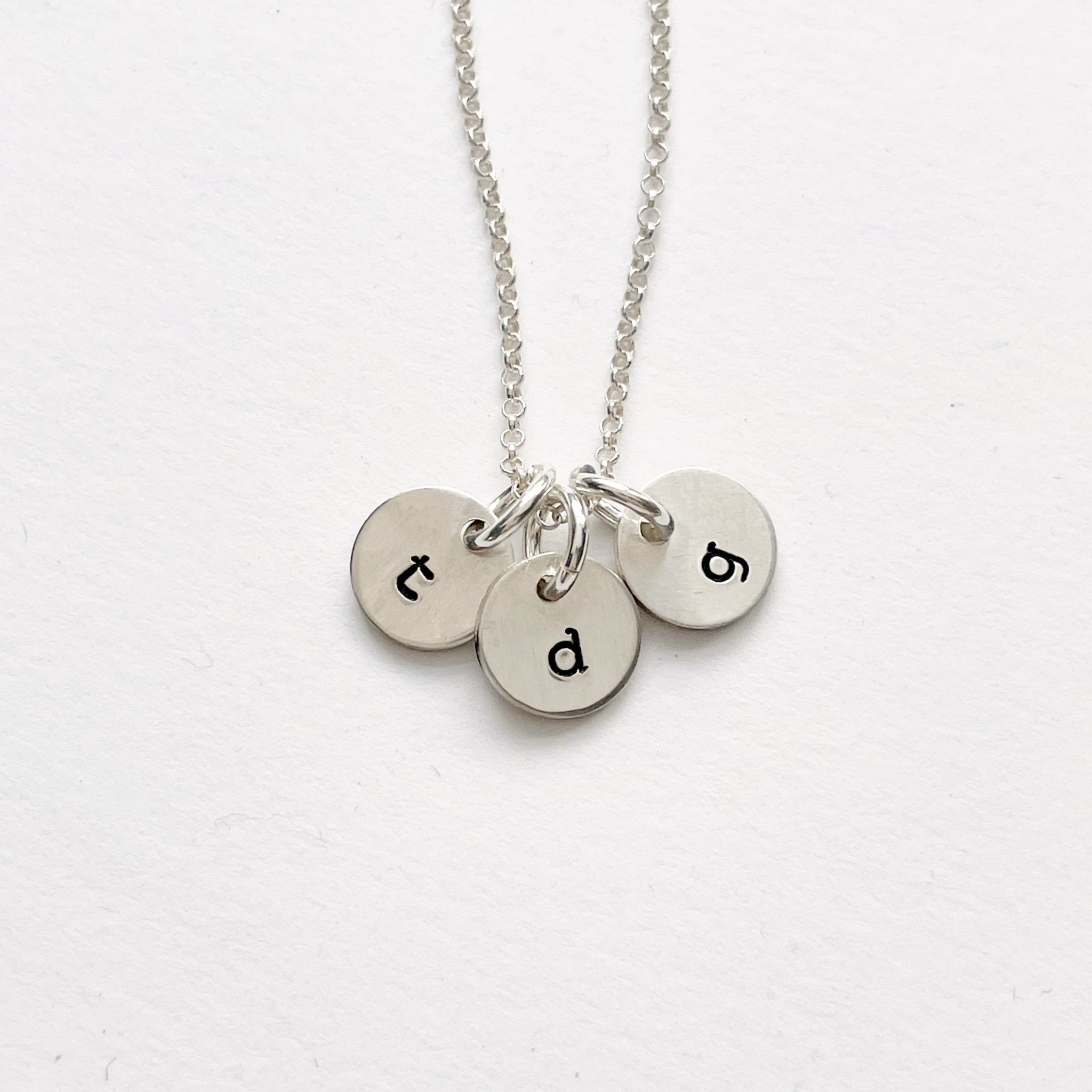 Silver stamped disc personalized initial necklace with 3 silver stamped discs with initials. Tabby Necklace by Sarah Cornwell Jewelry