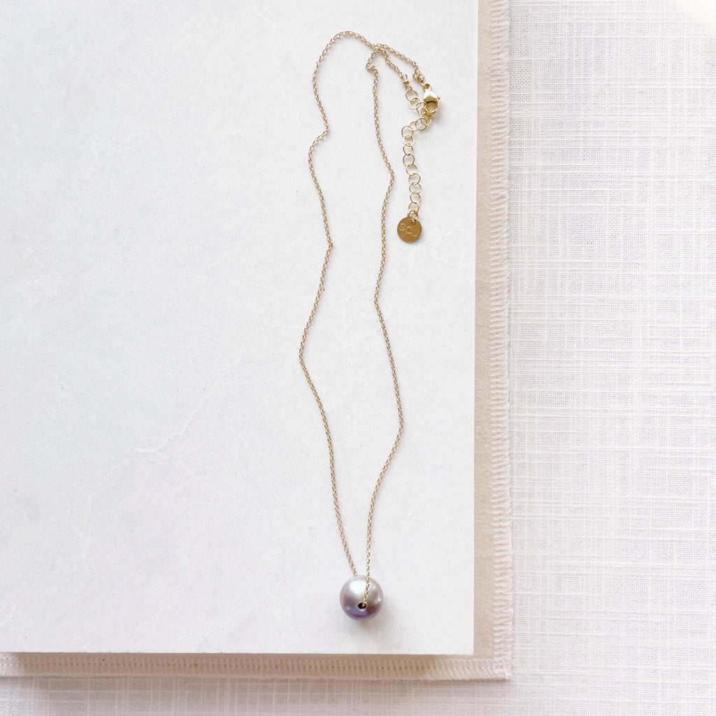Gold chain necklace with single large silver gray freshwater pearl. Tomlin Necklace by Sarah Cornwell Jewelry
