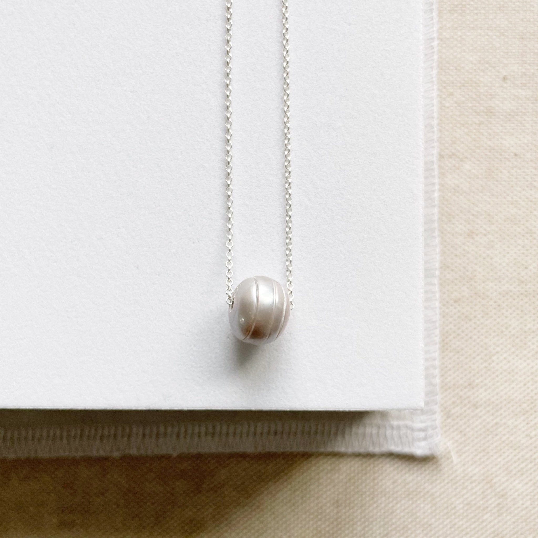 Silver chain necklace with single large silver gray freshwater pearl. Tomlin Necklace by Sarah Cornwell Jewelry