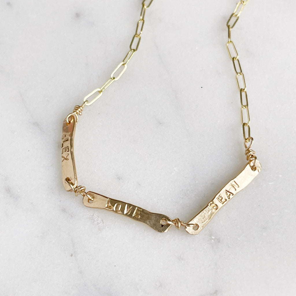 Gold link chain bracelet with 3 hand forged bars with hand stamped names. Tribe Bracelet by Sarah Cornwell Jewelry