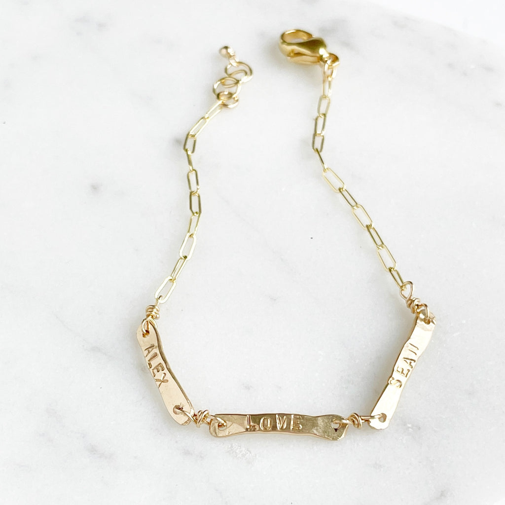 Gold link chain bracelet with 3 hand forged bars with hand stamped names. Tribe Bracelet by Sarah Cornwell Jewelry